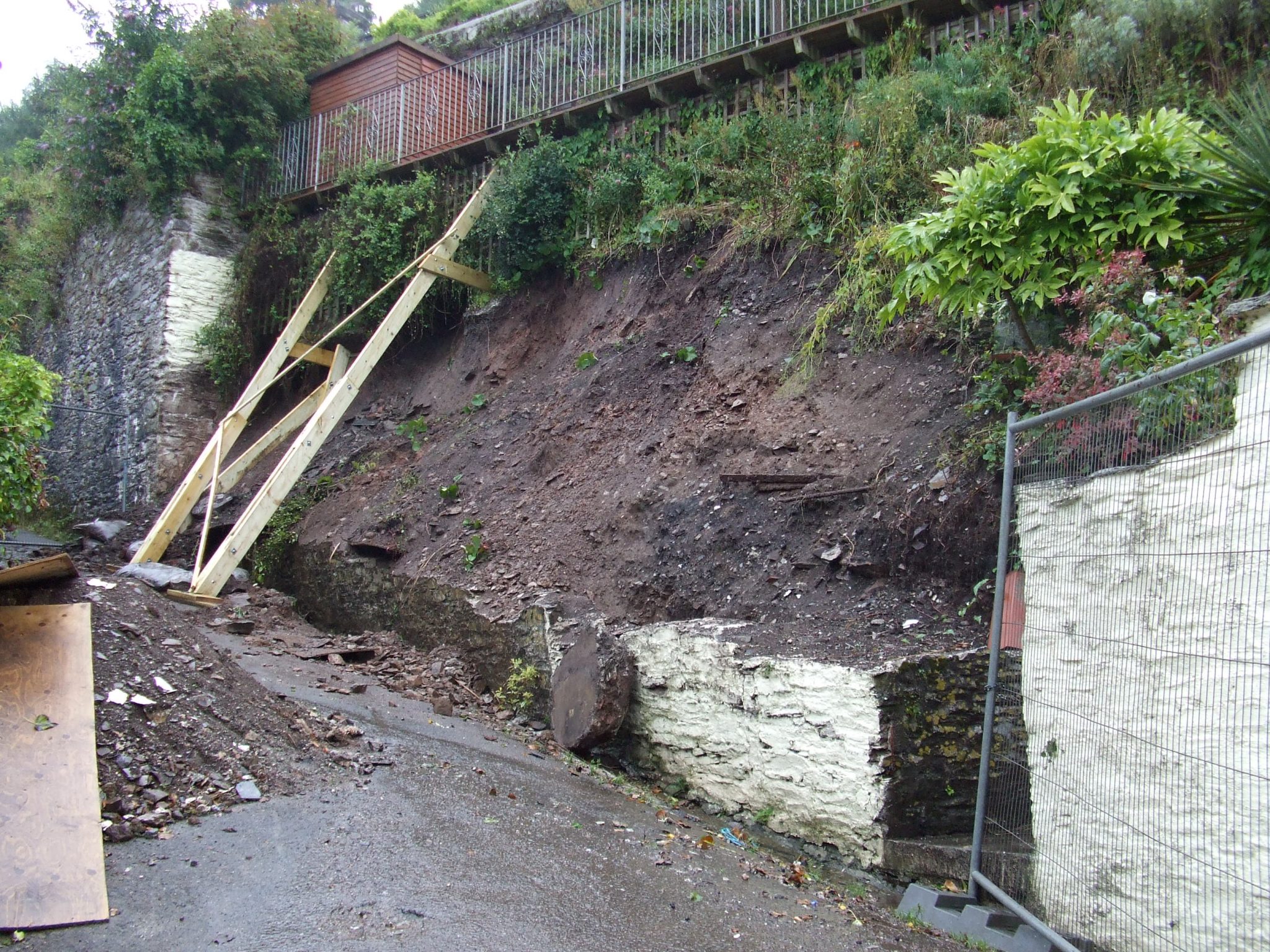 Retaining wall removed and structure above supported.