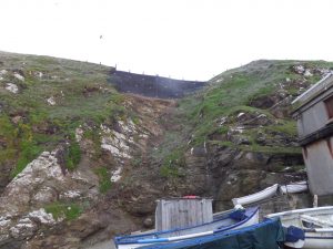 Slope stabilised with rock anchors and rockfall netting.
