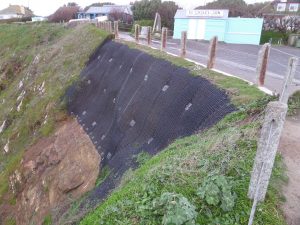 Slope stabilised with rock anchors and rockfall netting.